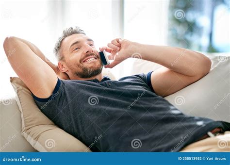 Enjoying His Day Off A Handsome Mature Man Relaxing On The Sofa At
