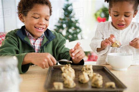 Black children baking cookies together - Stock Photo - Dissolve