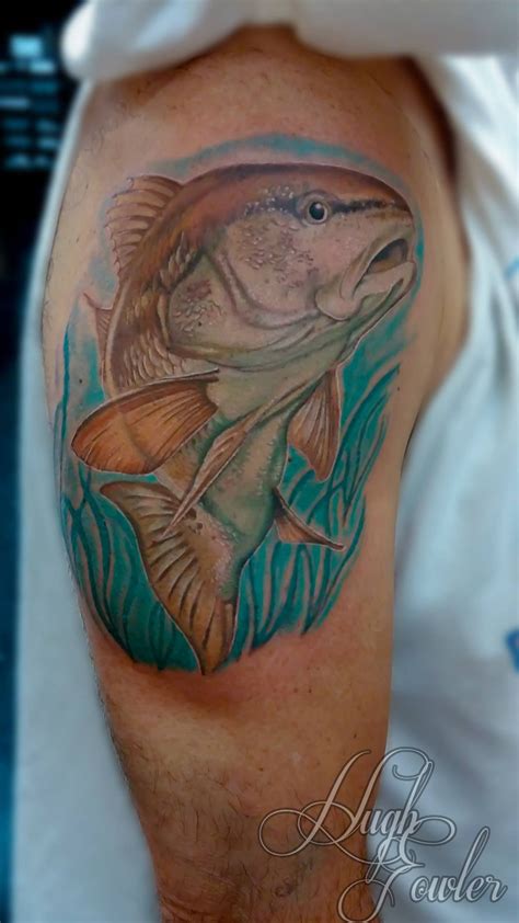 A Man With A Fish Tattoo On His Arm