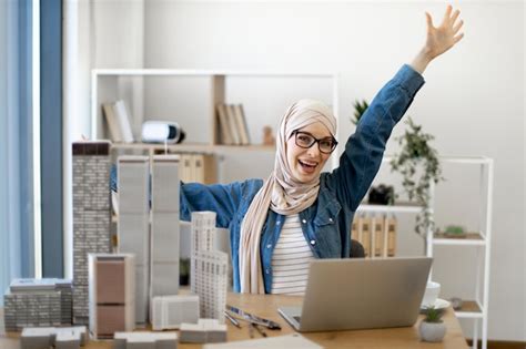 Premium Photo Female Raising Hands In Winners Gesture At Office Desk