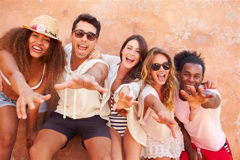 Group Of Friends On Holiday Together Posing By Wall Stock Image Image