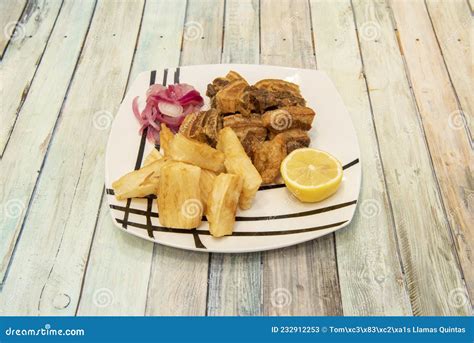 Delicious Latin American Dish Of Chicharrones With Fried Yucca And Red