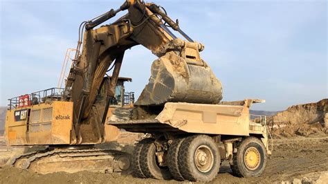 Huge Caterpillar 6040 Excavator Loading Terex TR100 And Hitachi Dumpers