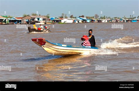 The Tonlé Sap River At Kampong Chhnang Is Busy With Boats Heading To