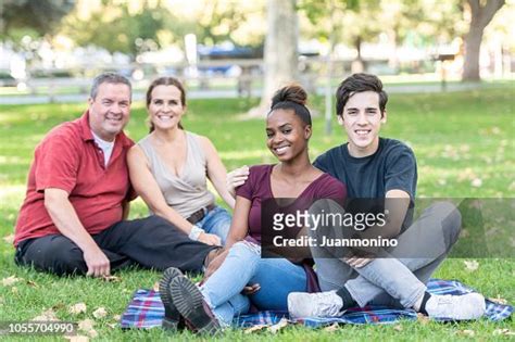 Mature Caucasian Couple Posing With Their Young Son And His Black Young Girlfriend High Res