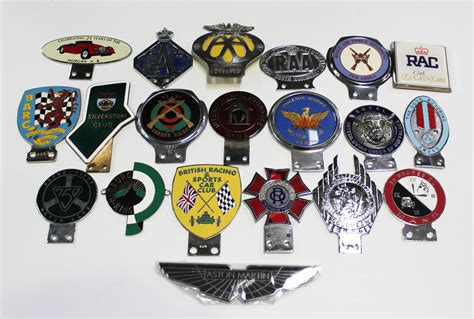 A Group Of Twenty Assorted Car Badges Including Brdc Silverstone Club