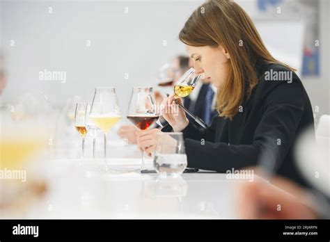 Female Sommelier Sniffing Unknown Alcoholic Drink During Blind Tasting