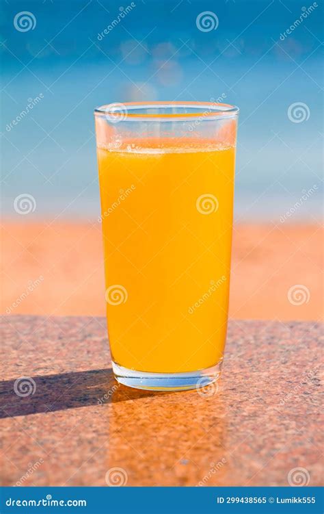 Glass Of Fresh Orange Juice On Blue Sea Background Stock Image Image