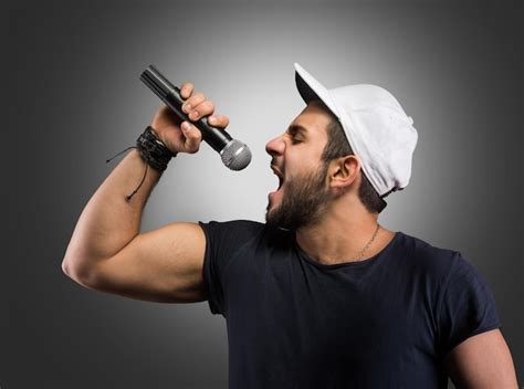 Premium Photo Young Man Singing Into A Microphone