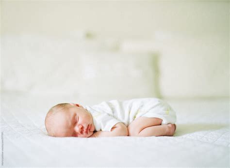 Newborn Baby Sleeping On His Belly On A Bed By Stocksy Contributor