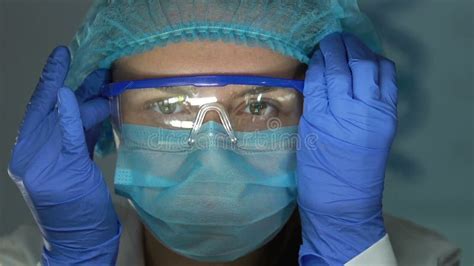 Female Lab Assistant Wearing Safety Glasses Before Chemical Research