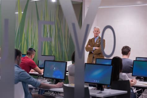 teacher and students in computer lab classroom 12445531 Stock Photo at Vecteezy