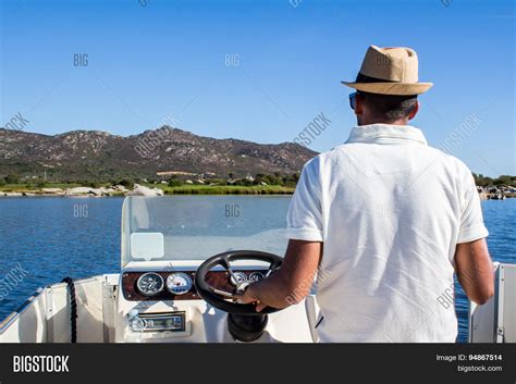 Man Driving Boat Near Image & Photo (Free Trial) | Bigstock