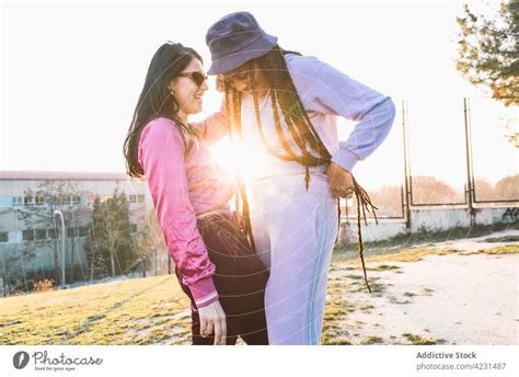 Lesbian Couple Kissing Against Urban House With Stairs A Royalty Free