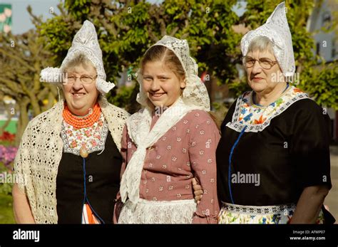 Three Dutch Ladies In Period Costumes Pose At The Tulip Festival In