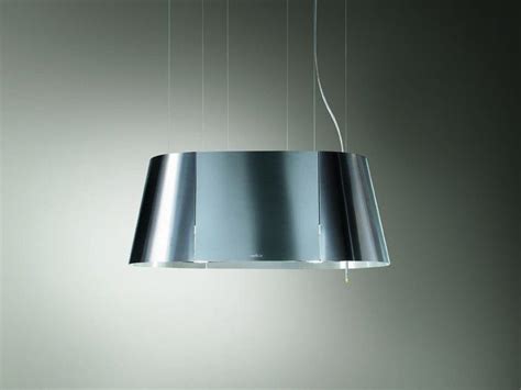 A Modern Light Fixture Hanging From A Ceiling In A Room With Grey Walls