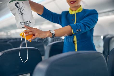 Air Hostess Showing How To Use An Oxygen Mask On Board Stock Image