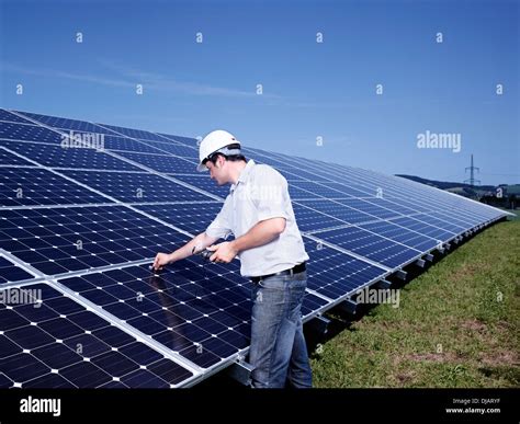 Solar Installation Technician Checking Solar Panels With A Measuring