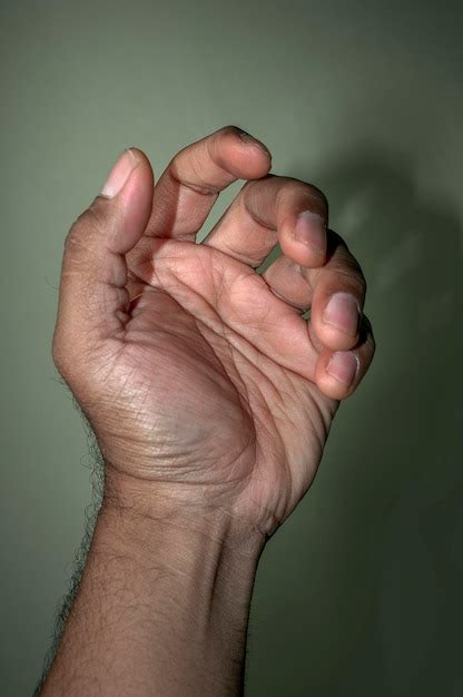 Premium Photo Cropped Hand Of Man Gesturing Against Wall