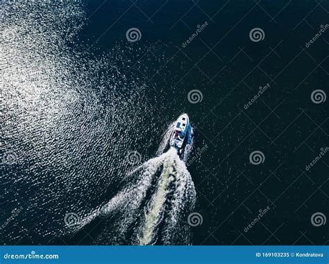 Aerial View Of Speed Boat Or Yacht At Blue Sea Or Lake Leaving A Wake