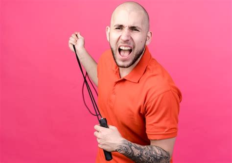 Free Photo Angry Young Sporty Man Stretching Jump Rope Isolated On