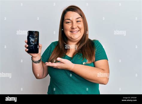 Beautiful Brunette Plus Size Woman Holding Broken Smartphone Showing