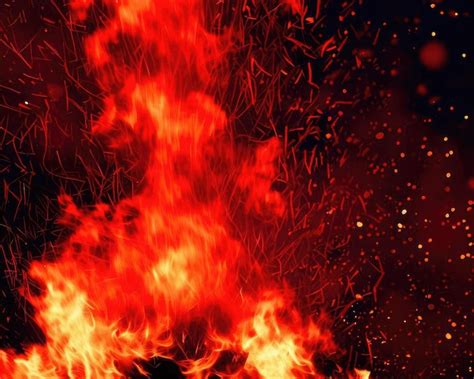 Premium AI Image Burning Red Hot Sparks Rise From A Large Fire In The Night Sky