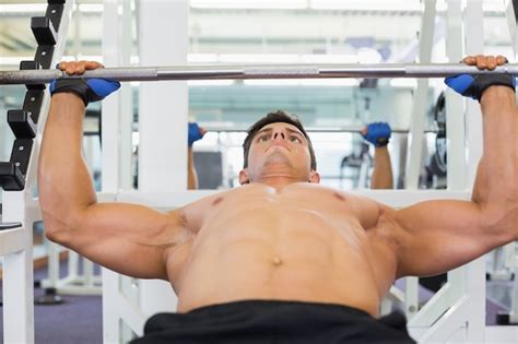 Premium Photo Shirtless Muscular Man Lifting Barbell