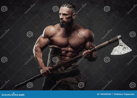 Northen Warrior Ready To Fight Holding Axe In Dark Background Stock