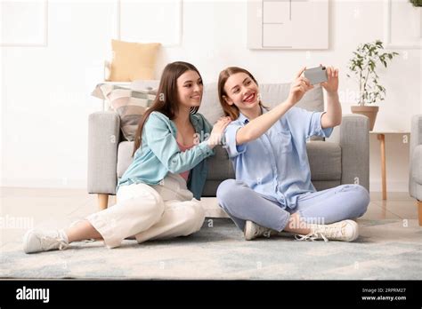 Female Friends With Mobile Phone Taking Selfie At Home Stock Photo Alamy