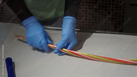 Confectioners Making Candies From Melted Colored Sugar By Rolling And Cutting In Candy Workshop