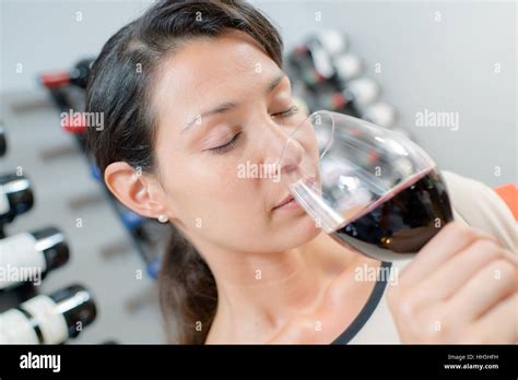 Brunette Smelling Red Wine Stock Photo Alamy