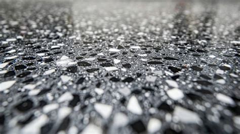 A Speckled Vinyl Flooring Closeup With A Smooth Glossy Finish Revealing
