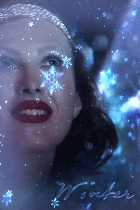 A Woman With Snowflakes On Her Head And Nose Is Looking Up At The Sky