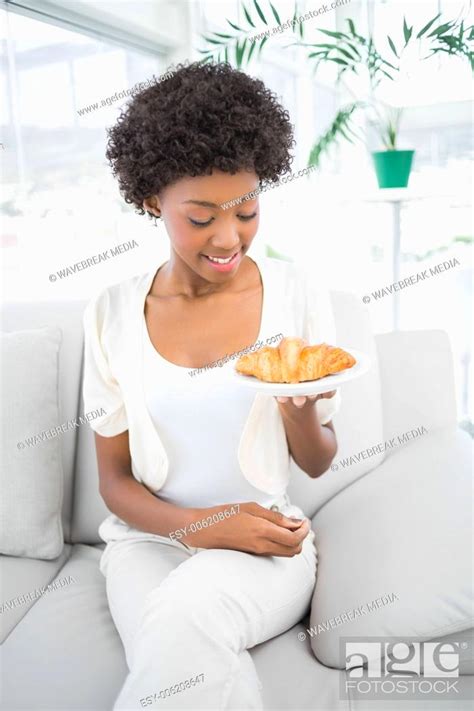 Smiling Pretty Brunette Holding Croissant Stock Photo Picture And Low