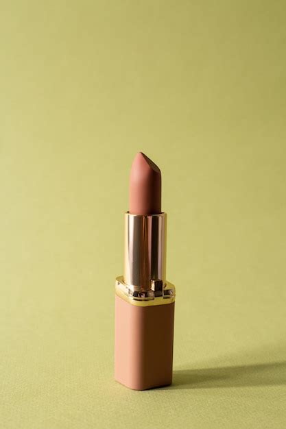 Premium Photo Nude Matte Lipstick With A Cap On Green Background Female Accessory For Lip