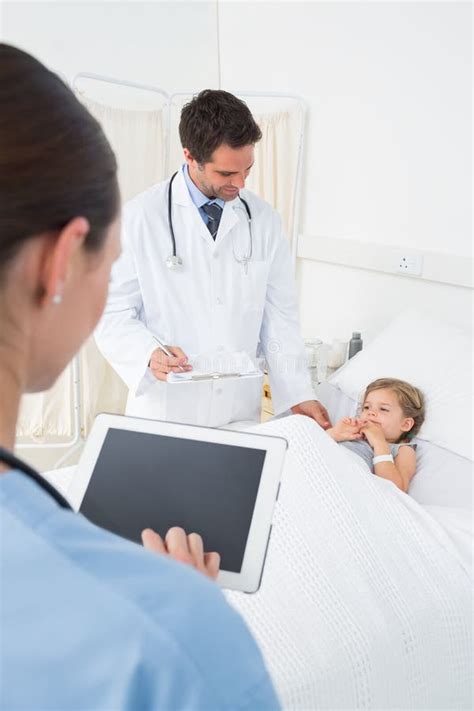 Doctors attending ill girl stock photo. Image of illness - 39228590