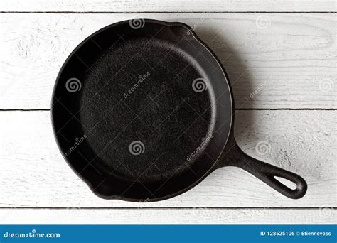 Empty Black Cast Iron Pan Isolated On White Painted Wood From Ab Stock