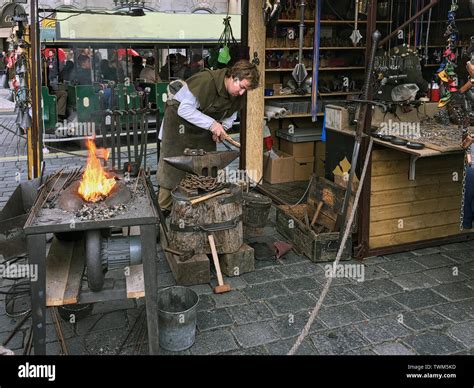 A Blacksmith At Work Forging Medieval Weapons Stock Photo Alamy