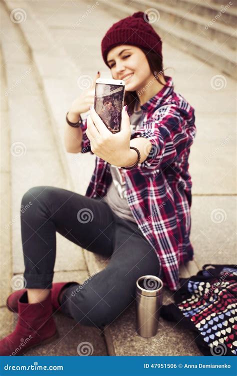 Brunette Woman In Hipster Outfit Sitting On Steps And Taking Selfie On