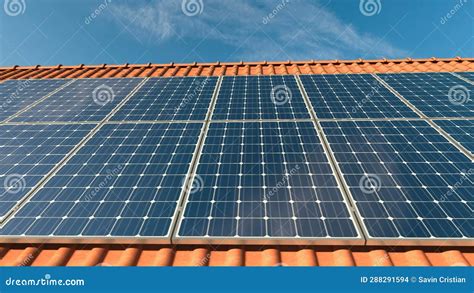 Solar Panels On A Tiled Roof With Clear Blue Sky Reflecting On The