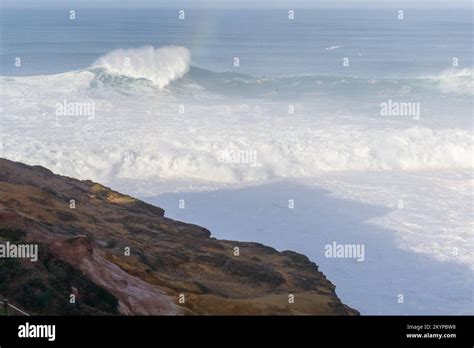 View from high cliff to the waves in Nazare Stock Photo - Alamy