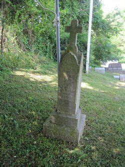 A Grave In The Middle Of A Grassy Area