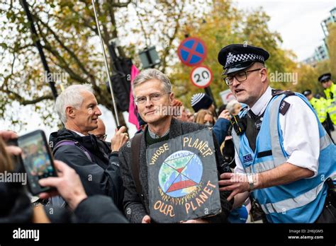 Police Engaging With A Protestor Refusing To Move From The Road Rise