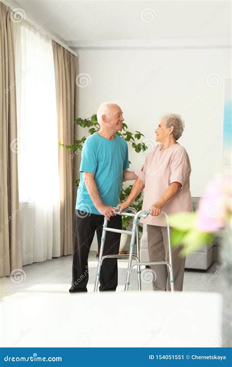 Elderly Man And His Wife With Walking Frame Stock Image Image Of