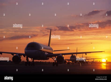 Planes Sitting On Tarmac At Sunset Stock Photo Alamy