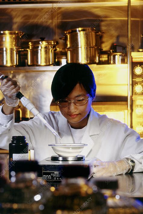 Technician Adding Folate To Apple Sauce Stock Image T