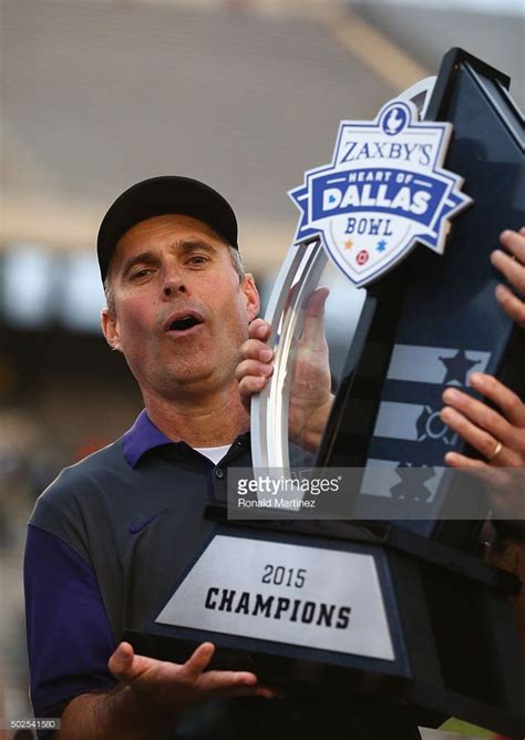 Head Coach Chris Petersen Of The Washington Huskies Holds Up The