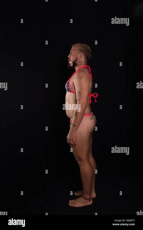 Man Wearing Bikini Standing Still Isolated On Dark Background Stock