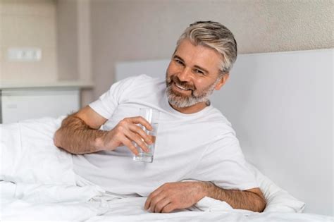 Premium Photo Happy Mature Caucasian Man Holding Glass Of Water